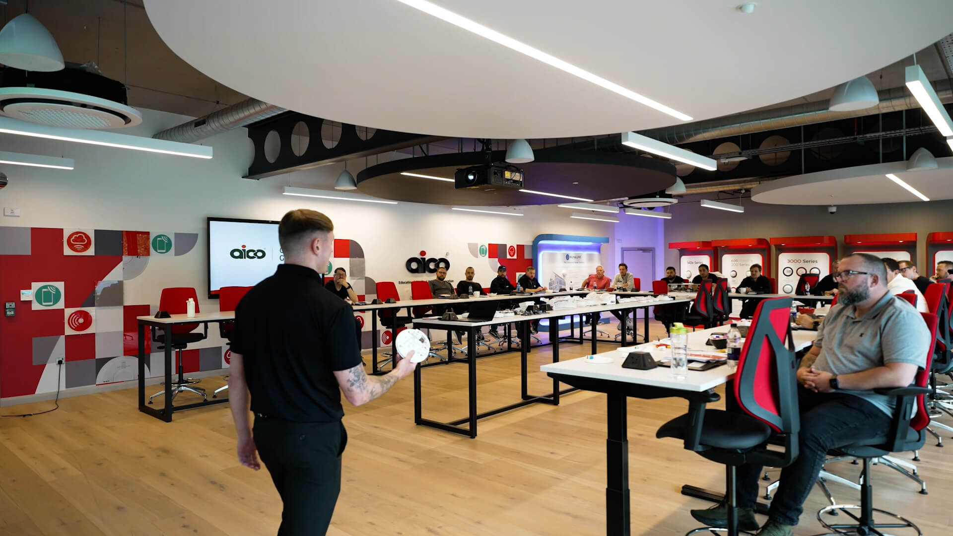 A man giving a presentation in a modern open place office